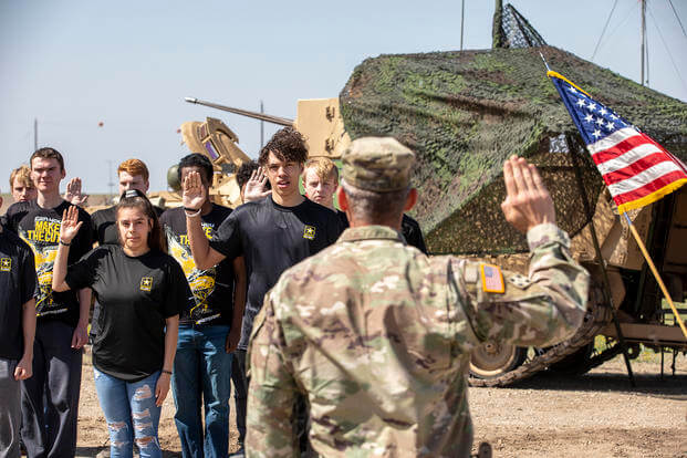 U.S. Army Lt. Col. Richard A. Montcalm, the commander of 1st Squadron, 4th Cavalry Regiment, 1st Armored Brigade Combat Team, 1st Infantry Division, gives the Oath of Enlistment, April 18, 2023, at the Douthit Gunnery Complex on Fort Riley, Kansas.